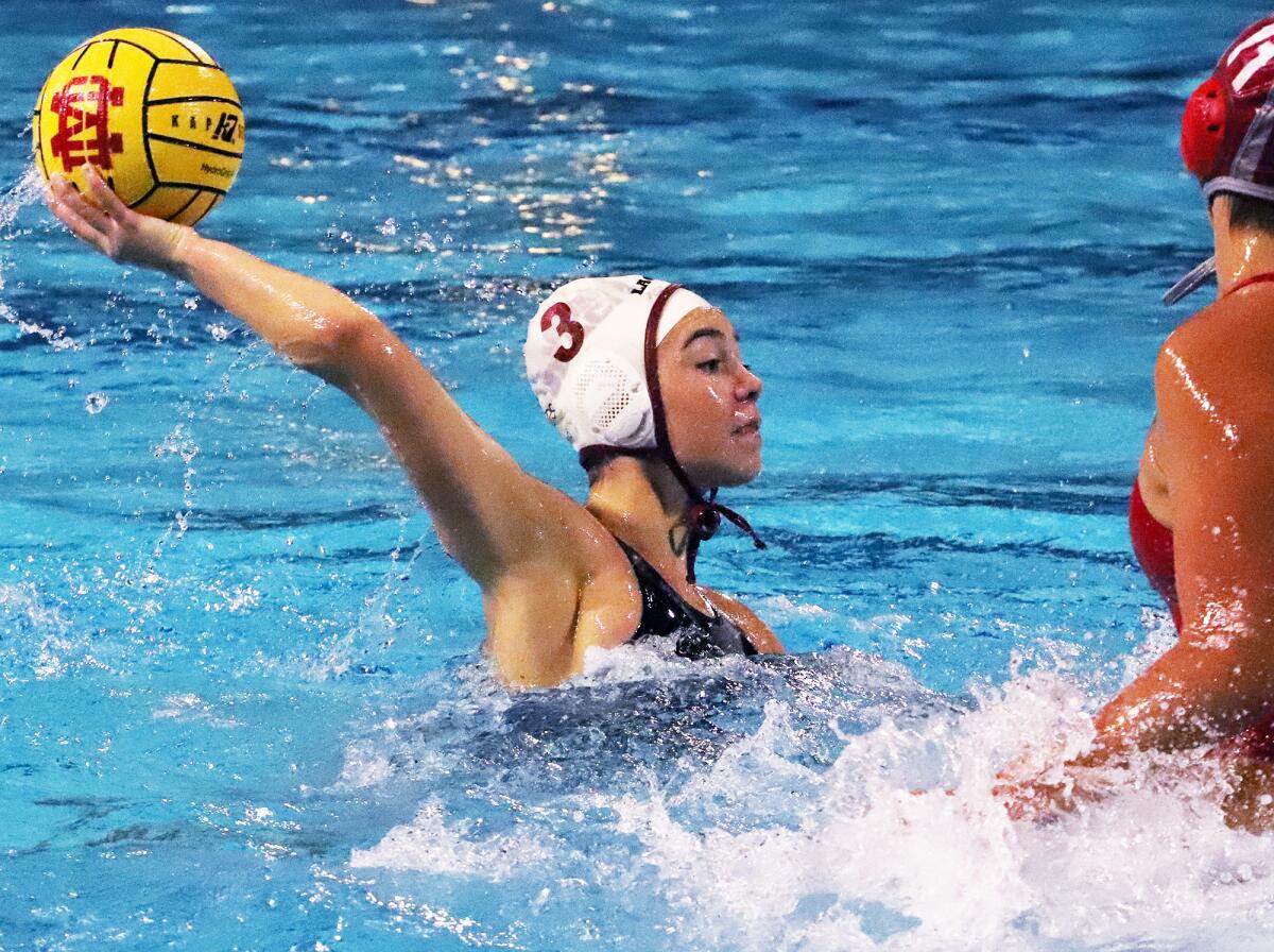 Laguna Beach's Emmy Hensley (3) tries to pass over a Mater Dei defender on Thursday night.
