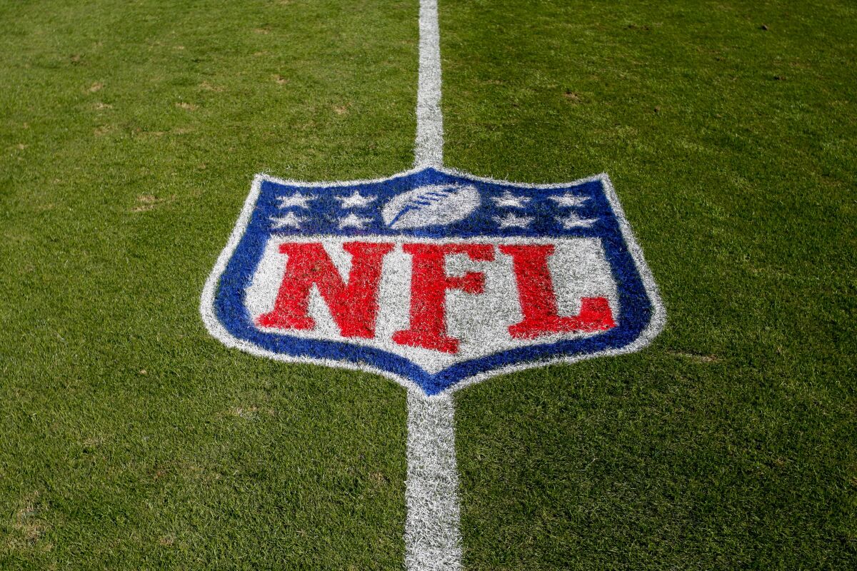 NFL logo painted on grass.