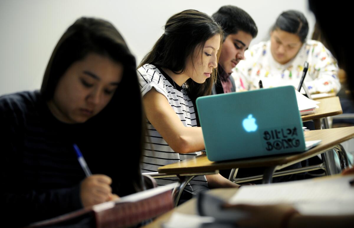 Cal State Dominguez freshmen including Tarah Medellin, center, do classwork in a class that is part of the freshman First-Year Experience, designed to help students stay in school.