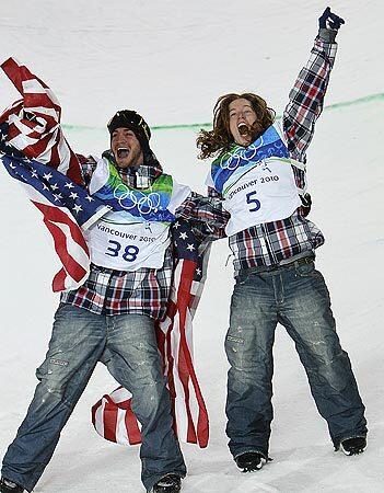 U.S. teammates and men's snowboard halfpipe competitors Scott Lago, left (bronze medal) and Shaun White (gold) have reason to be happy after the event Wednesday night.