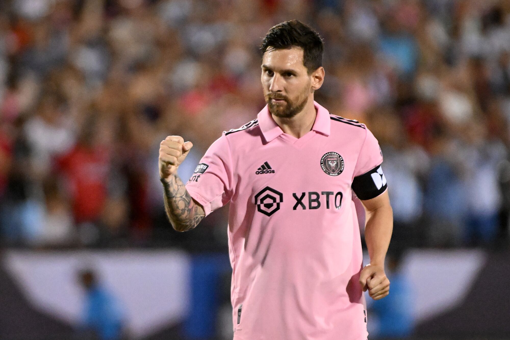 Lionel Messi pumps his fist in front of a crowd.