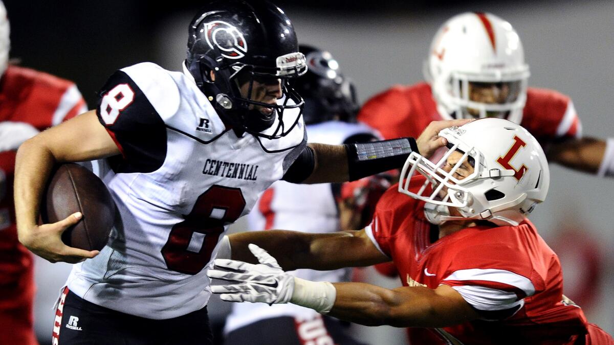 Corona Centennial quartback Anthony Catalano evades an Orange Lutheran defender on a 61-yard scoring run during a game Sept. 11.