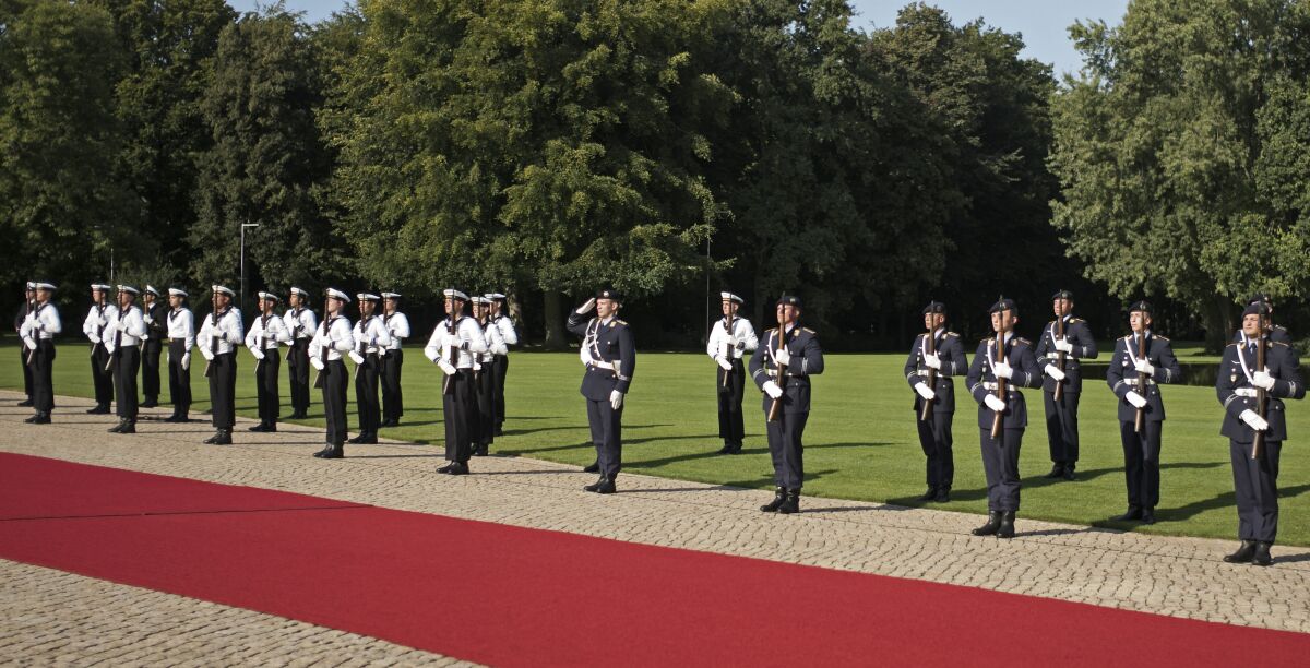 FILE - In this Sept. 11, 2020 file photo , German honour guards keep in distance during the welcoming ceremony for Croatia's President Zoran Milanovic at Bellevue Palace in Berlin, Germany. A company of the German military's honor guard battalion has been suspended from official duty amid an investigation of initiation rituals, suspected sexual abuse and far-right incidents, the German Defense Ministry said Friday. (AP Photo/Markus Schreiber, File)