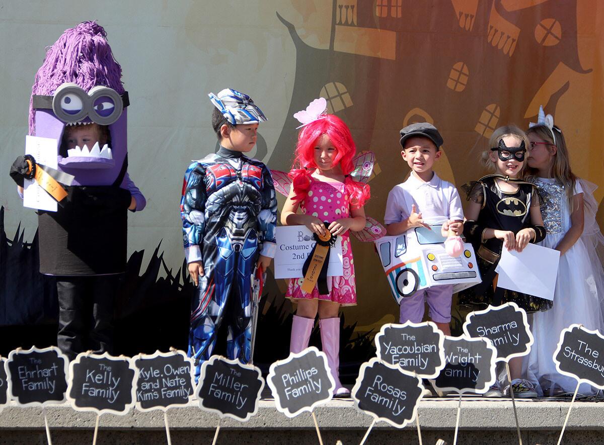 Hudson Stoner, 5, left, took first place in the first grade costume contest with his evil minion costume at the annual La Canada Elementary Halloween Haunt, at the school in La Canada Flintridge on Saturday, Oct. 27, 2018.