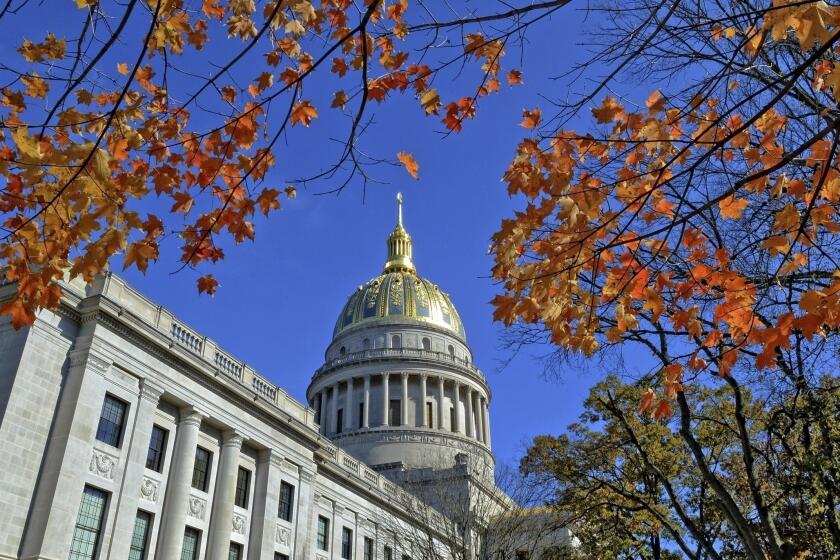 FILE - The West Virginia Capitol with its dome framed by turning sugar maples leaves is seen, Nov. 3, 2014, in Charleston, W.Va. Lawmakers in West Virginia's GOP-controlled state Legislature voted Saturday, March 9, 2024, to allow some students who don't attend traditional public schools to be exempt from state vaccination requirements that have long been held up as some of the most strict in the country. (Tom Hindman/The Daily Mail via AP, File)