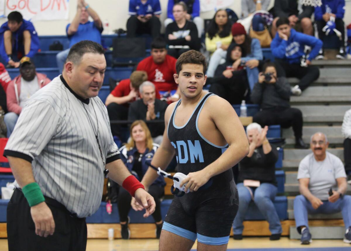 Corona del Mar's Emilio Franco is all smiles after winning a 220-pound semifinal match during the Sunset Conference wrestling finals at Corona del Mar High School on Saturday.
