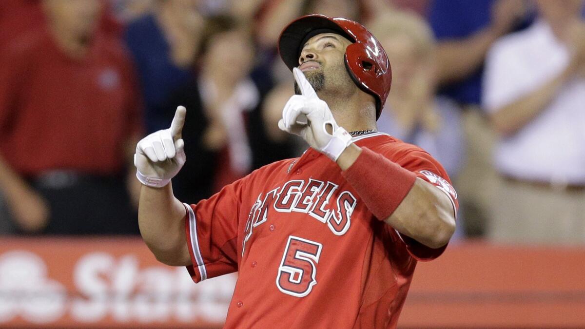 Angels first baseman Albert Pujols celebrates after hitting a home run during the seventh inning of a 4-3 victory over the Houston Astros at Angel Stadium on Monday.