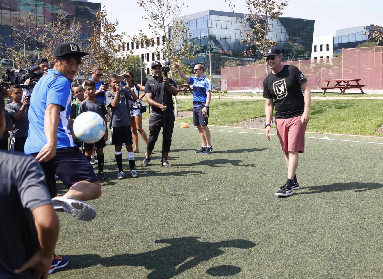 Actor Will Ferrell, right, co-owner of the Los Angeles Football Club, and Leicester City's Shinji Okazaki play during a soccer clinic and practice at the Central Park at Playa Vista in Los Angeles on Friday, July 29, 2016. Leicester City is scheduled to face Paris Saint-Germain on Saturday in an International Champions Cup soccer match. (AP Photo/Nick Ut)
