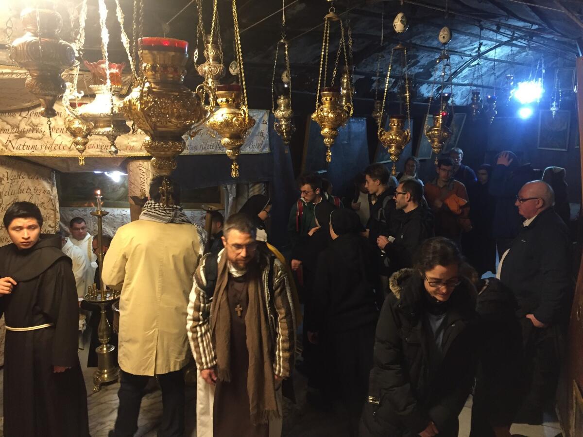 People attend a Mass on Christmas Day at the Church of the Nativity.