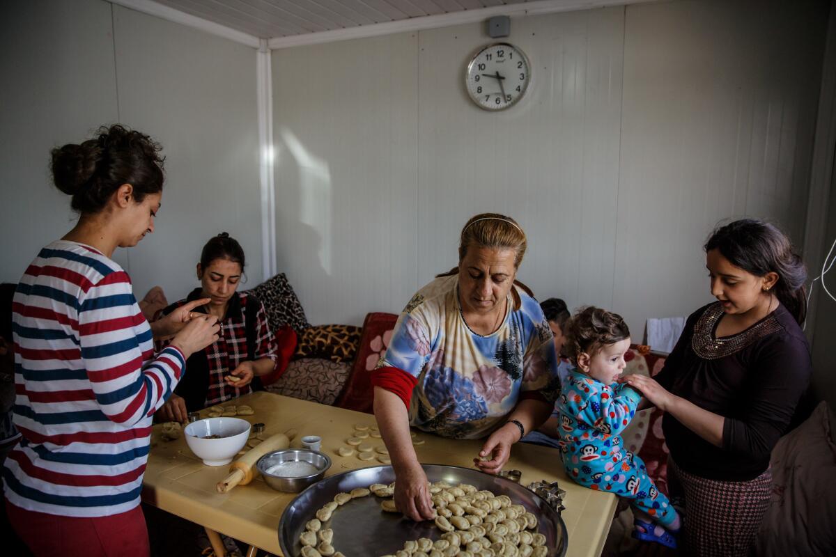 Suad Rahim makes klecha holiday cookies with her family at a Christian refugee camp in the Ainkawa neighborhood of Irbil on April 12. (Marcus Yam / Los Angeles Times)