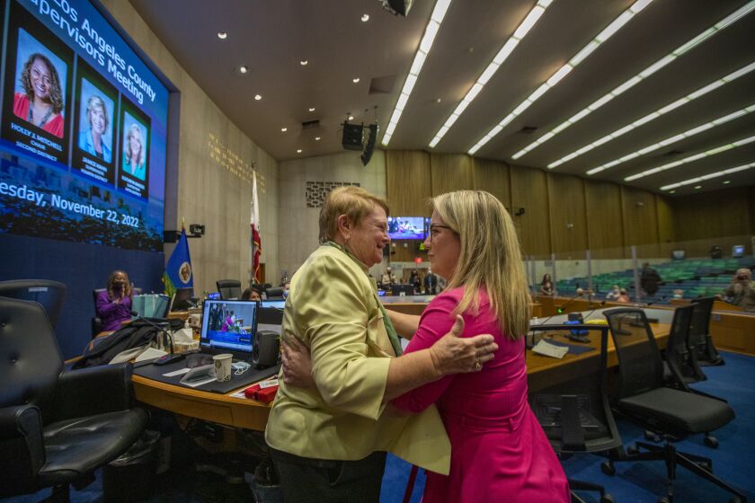 Los Angeles, CA - November 22: Los Angeles County Board of Supervisor Sheila Kuehl, left, hugs West Hollywood City Councilmember Lindsey Horvath, right, on Tuesday, Nov. 22, 2022, in Los Angeles, CA. Today is Kuehl's last day as LA County Board of Supervisor. Horvath will be replacing her seat. (Francine Orr / Los Angeles Times)