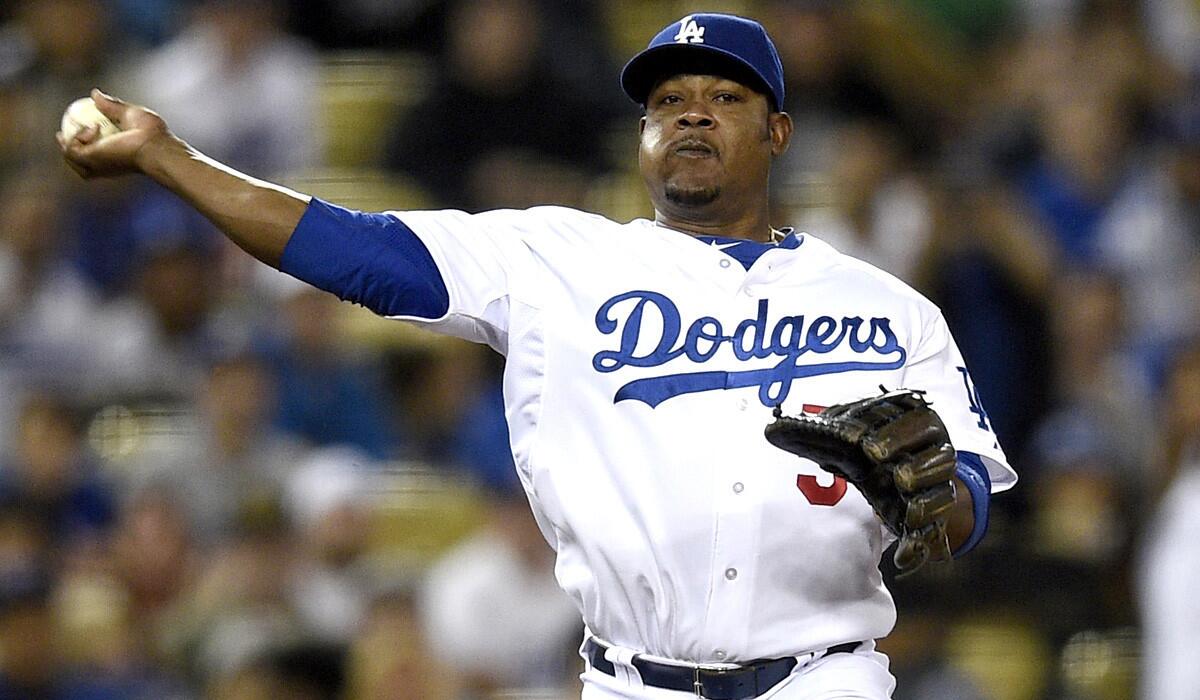 Dodgers third baseman Juan Uribe throws to first base to put out a Giants batter in the fifth inning Thursday night.