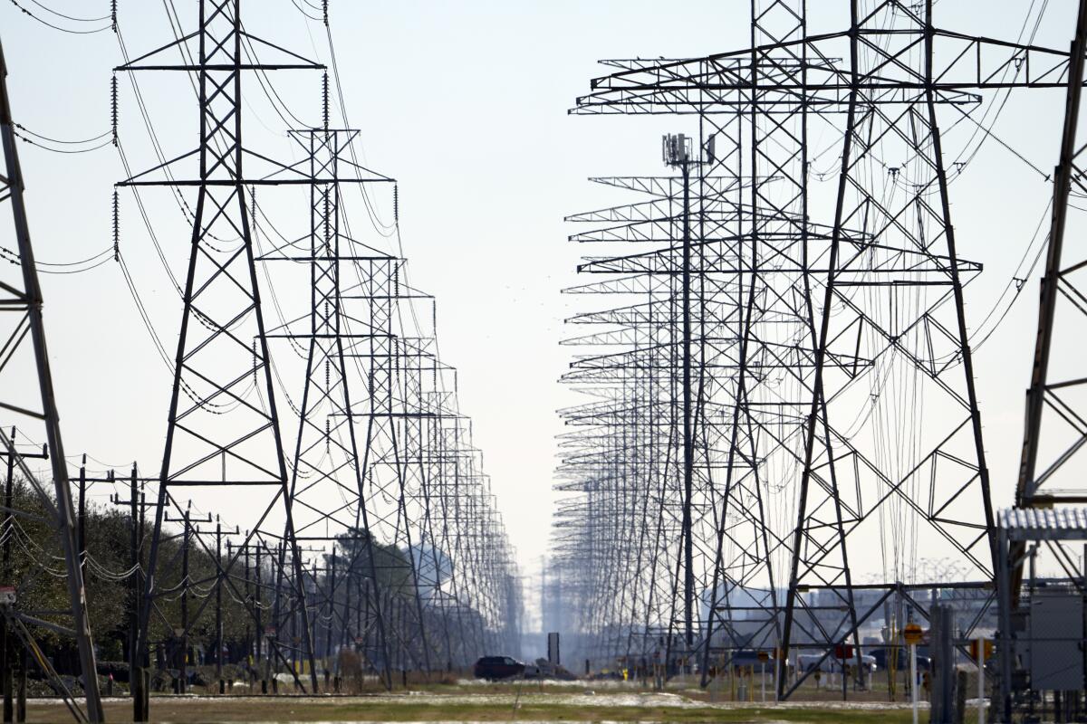 FILE - This Tuesday, Feb. 16, 2021 file photo shows power lines in Houston. The electric grid manager for most of Texas issued an electricity conservation watch Tuesday, April 13, 2021 appealing to customers to conserve electricity despite weather conditions typical for spring. (AP Photo/David J. Phillip)