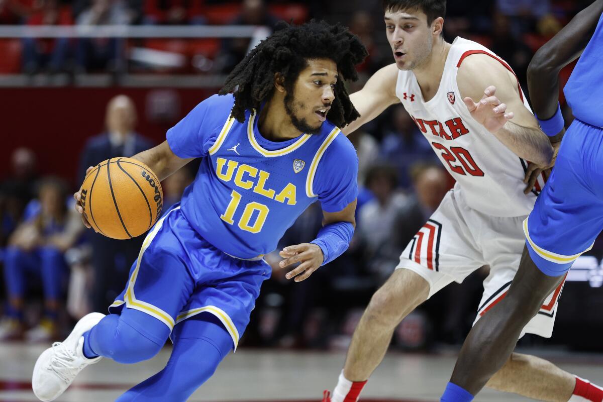 UCLA guard Tyger Campbell drives against Utah guard Lazar Stefanovic during the first half.