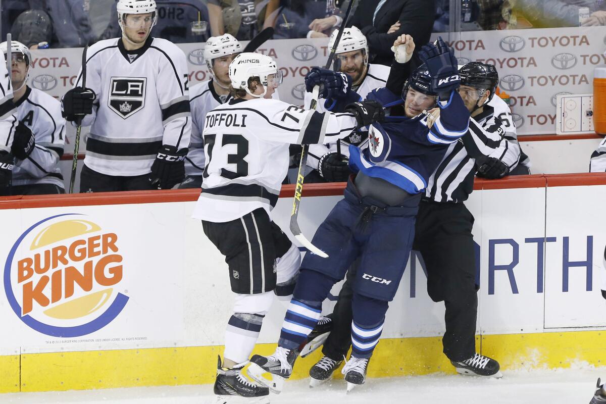Kings forward Tyler Toffoli (73) checks Jets center Marko Dano (56) during the third period of a game on March 24.