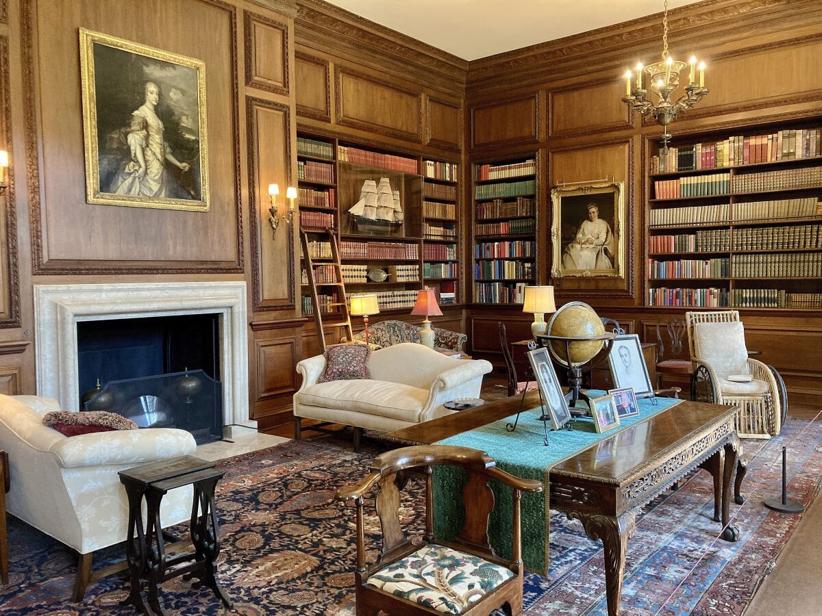 The library features period furnishings and built-in bookcases.