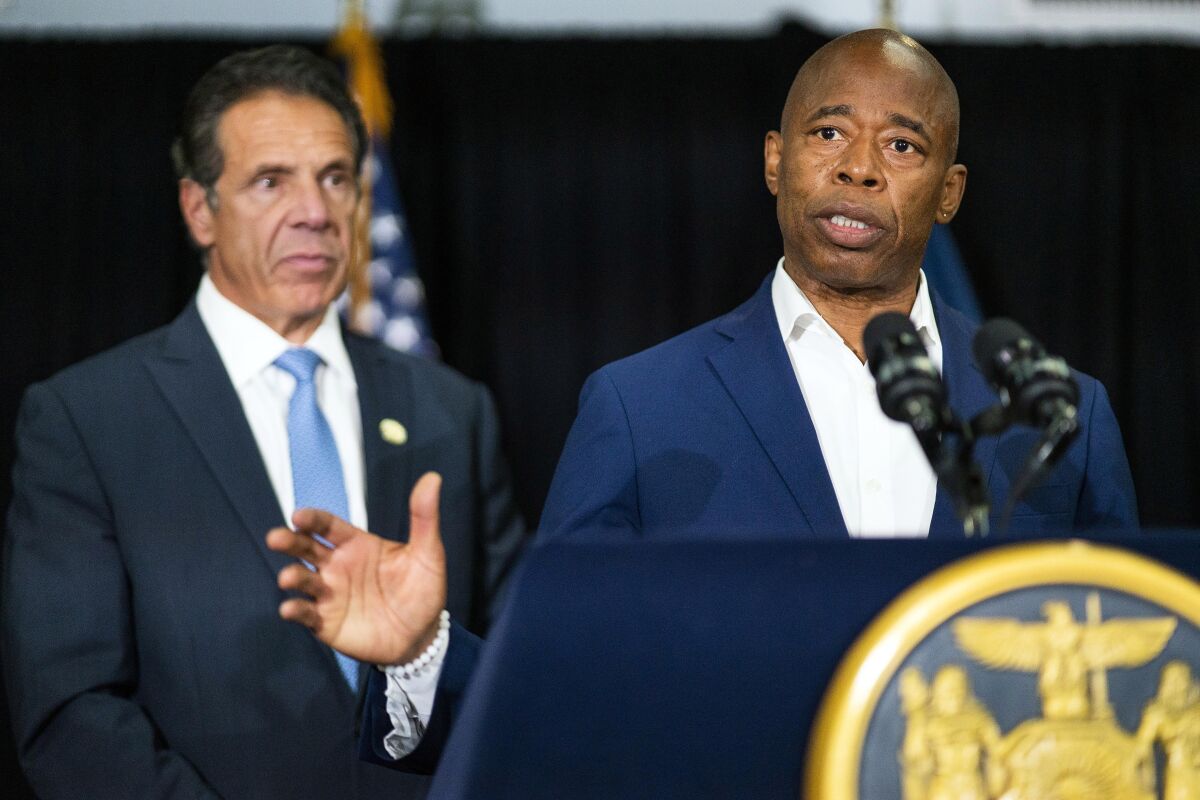 FILE — Brooklyn Borough President and New York City mayoral candidate Eric Adams, right, speaks to the media accompanied by Gov. Andrew Cuomo during a news conference, July 14, 2021. Adams pushed back Thursday, Feb. 3, 2022, against the suggestion there was anything wrong with his dinner this week with former New York Gov. Andrew Cuomo, who resigned amid allegations of sexual harassment last summer. (AP Photo/Eduardo Munoz Alvarez, File)