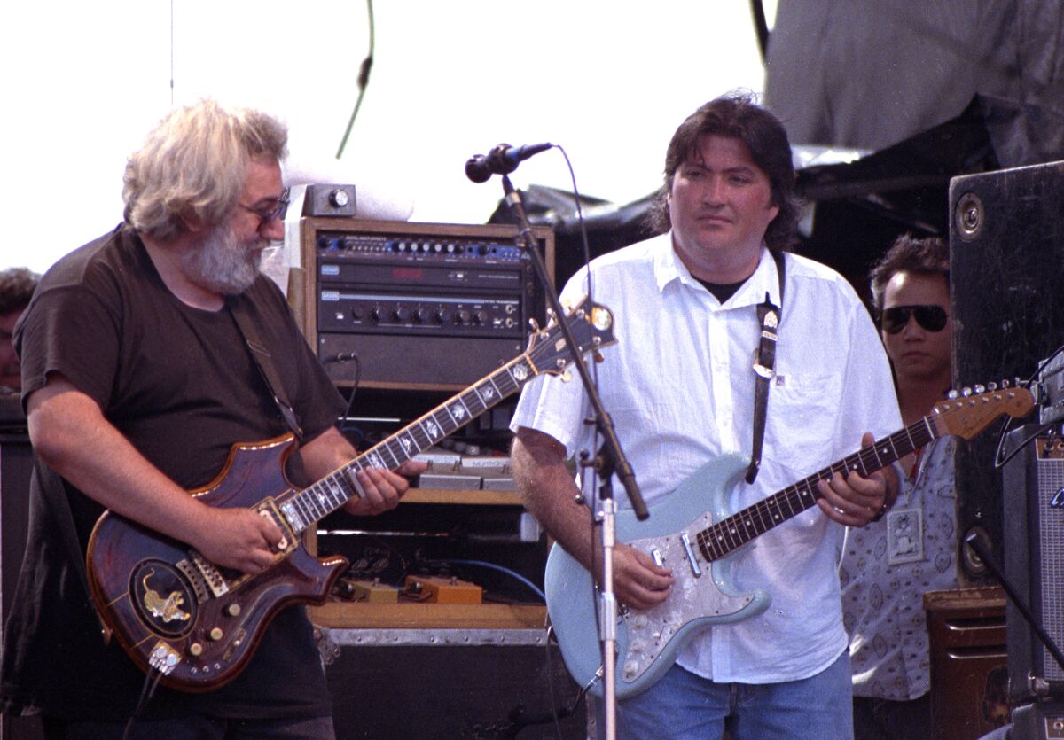 Jerry Garcia and David Hidalgo play guitars as they perform at Laguna Seca Raceway.