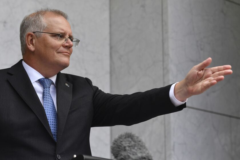 Australian Prime Minister Scott Morrison speaks to the media during a press conference in Canberra, Monday, Feb. 7, 2022. Morrison said that the county's border would reopen to all vaccinated visas holders from Feb. 21. (Mick Tsikas/AAP Image via AP)