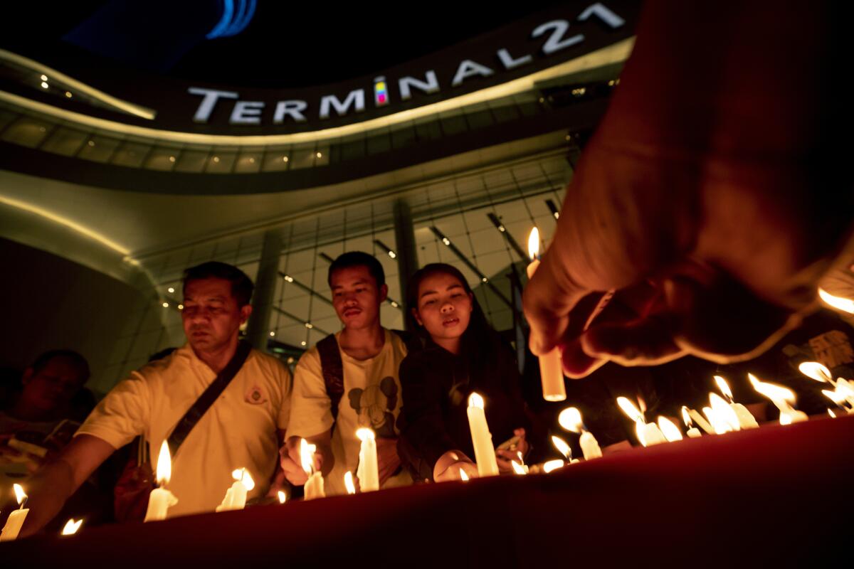 People attend a memorial service at the Terminal 21 Korat shopping mall in Thailand following a Feb. 8 mass shooting.