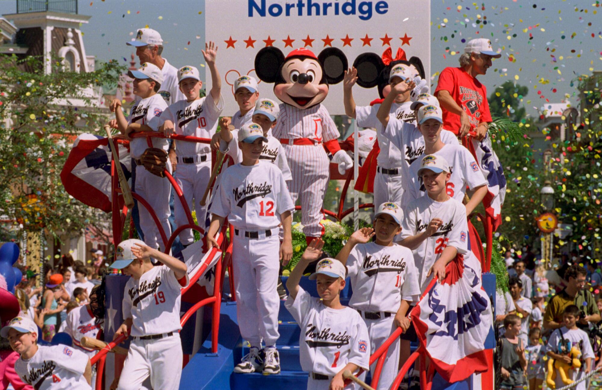 Young ballplayers on a float with a baseball uniformed Mickey Mouse.