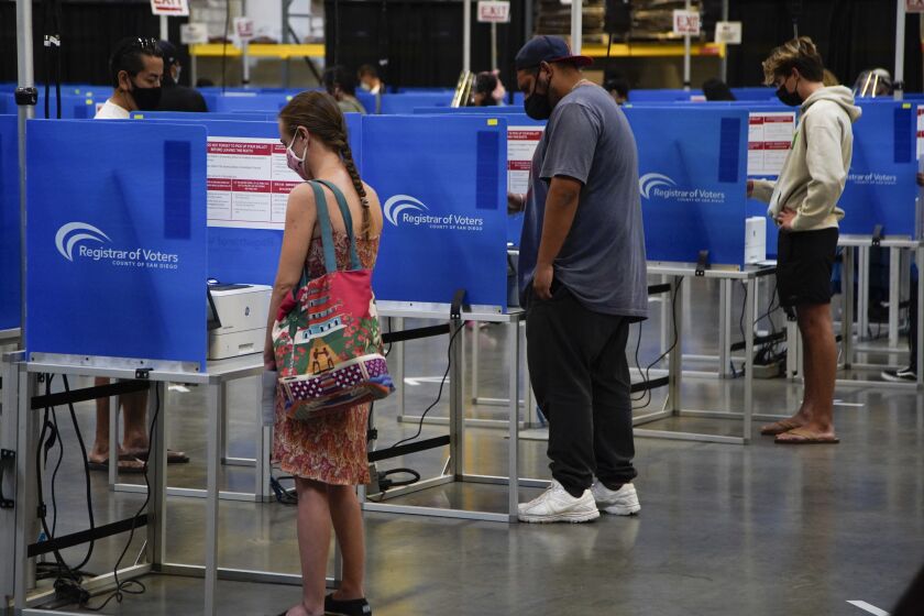 SAN DIEGO, CALIFORNIA - NOVEMBER 03: Voters casting their votes. Due to the pandemic Election Day voting taking place in the large warehouse area at San Diego Registrar of Voters on Tuesday, Nov. 3, 2020 in San Diego, California. (Alejandro Tamayo / The San Diego Union-Tribune)