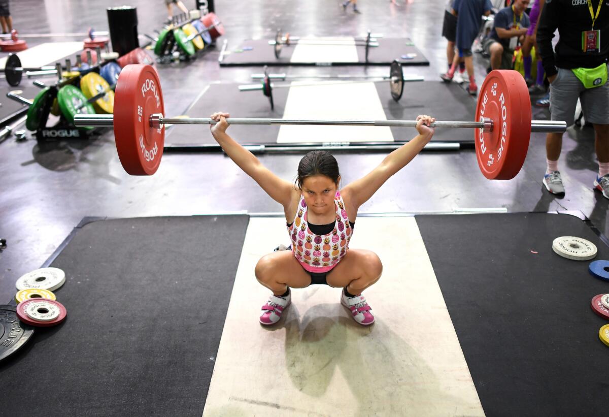 Alexys Bailor warms-up before the 13 and under category at the USA Weightlifting National Youth Championship. (Wally Skalij / Los Angeles Times)