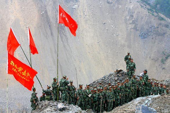 Soldiers prepare to dig a water diversion channel to drain the Tangjiashan mountain "quake lake" in Beichuan County of Sichuan Province, China. China has planned to evacuate 100,000 people threatened by the swelling lake formed by the earthquake. More than 68,000 people are now known to have died in the quake, and Chinese aid workers are struggling to find shelter for millions who lost their homes.