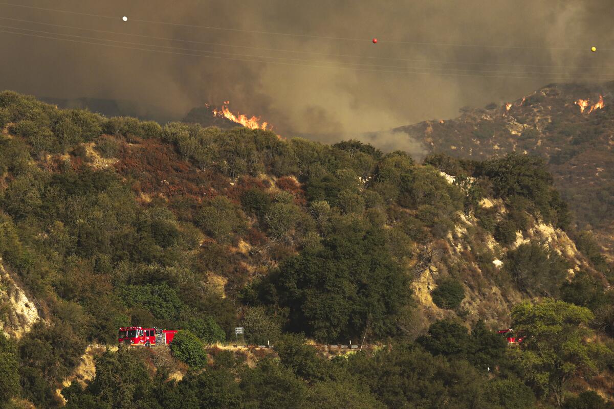 The Bobcat fire rages above Rincon Fire Station on Highway 39 on Wednesday in the San Gabriel Mountains.