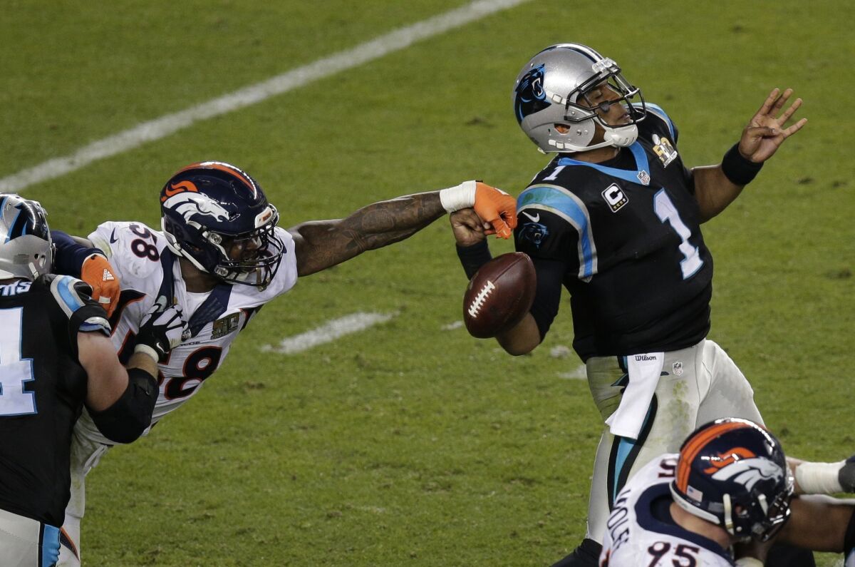 The Broncos' Von Miller (58) strips the ball from the Panthers' Cam Newton during the second half of Super Bowl 50.