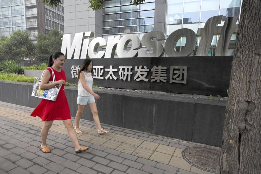 Chinese anti-monopoly investigators have raided Microsoft’s offices, and the government has banned Windows 8 from state computers. Above, the company's logo in Beijing.
