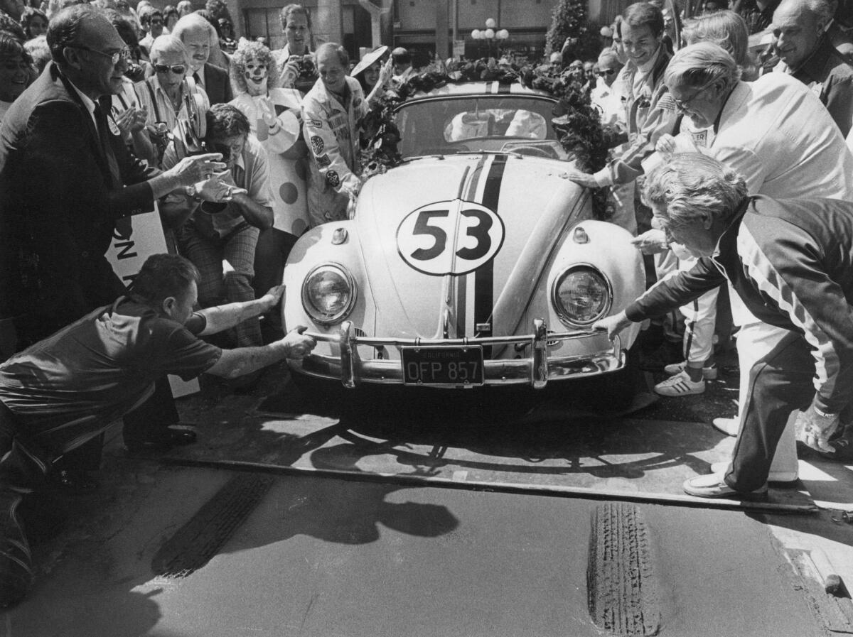 Herbie the love bug leaves a tireprint in the wet cement at the Chinese Theatre in Hollywood for the opening of "Herbie Goes to Monte Carlo," in 1977. (Robert Lachman / Los Angeles Times)
