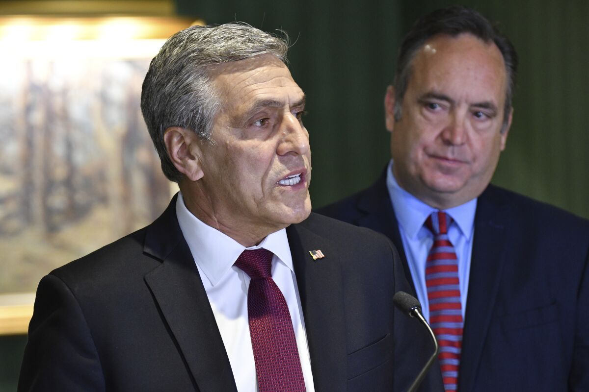 Lou Barletta speaks at a news conference where he accepted the endorsement of a rival in Pennsylvania's crowded Republican primary for governor, Jake Corman, right, May 12, 2022, in Harrisburg, Pa. Corman's endorsement comes as GOP leaders warn that leading Republican primary candidate Doug Mastriano is too far right to win in a general election. (AP Photo/Marc Levy)