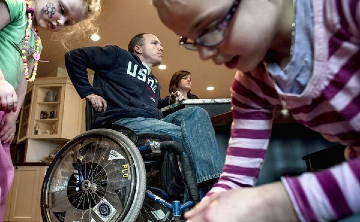 Air Force veteran Sean Halstead is shown with his wife Sarah and two of their children at their home in Rathdrum, Idaho. Halstead sustained a spinal cord injury during training and the couple couldn't have had children without in vitro fertilization. They were shocked to learn the VA doesn't cover the procedure.