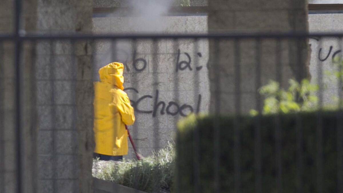 A worker power washed a wall with a spray painted threat on it. Security was heavy at Rancho Bernardo High School after threats spray-painted on walls and pavement around campus threatened a shooting.