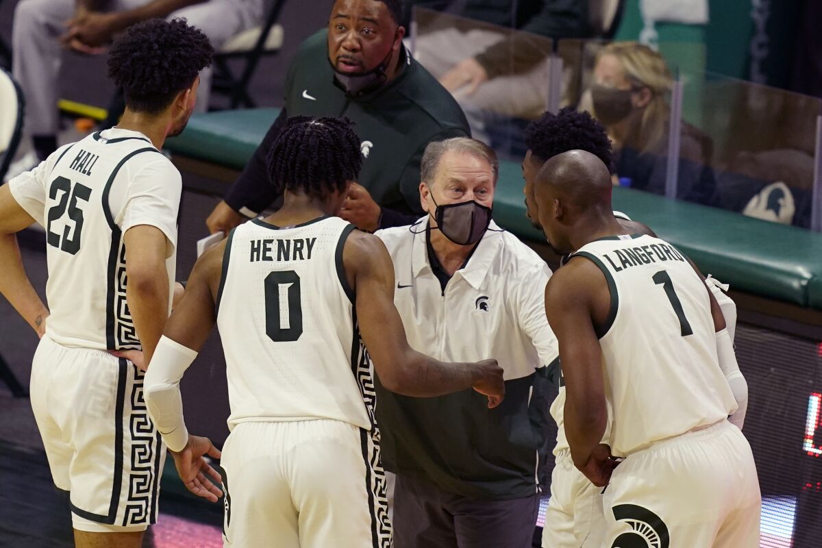 Michigan State coach Tom Izzo speaks with his players during a game on March 7.