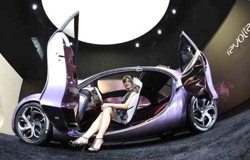 A hostess poses for photographers in a Citroen Revolte during the 63rd International Motor Show (IAA) in the central German city of Frankfurt am Main on September 15, 2009.