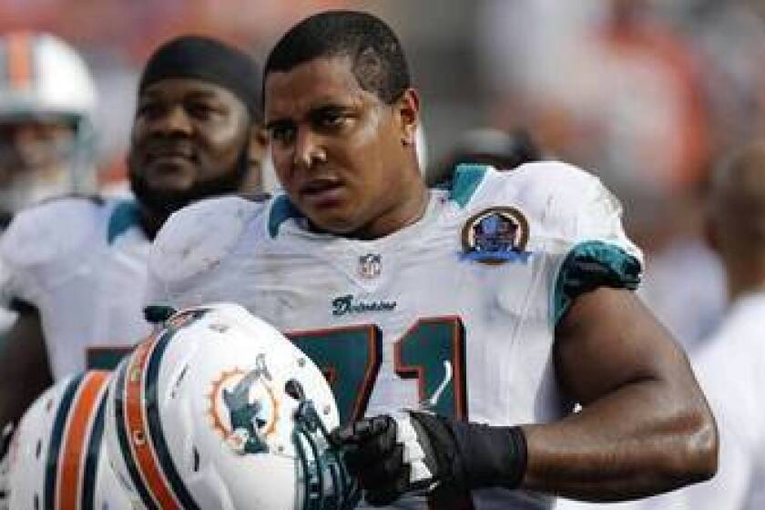 Miami Dolphins tackle Jonathan Martin watches from the sidelines during the second half of a game against the Jacksonville Jaguars in 2012.