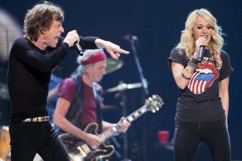Mick Jagger performs with Carrie Underwood during the Rolling Stones concert in Toronto on May 25, 2013.
