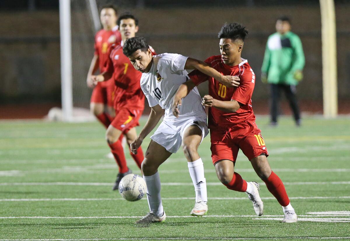 Ocean View’s Anthony Ruiz, right, and Segerstrom's Eduardo Lemus battle for the ball in a Golden West League match on Monday in Huntington Beach.