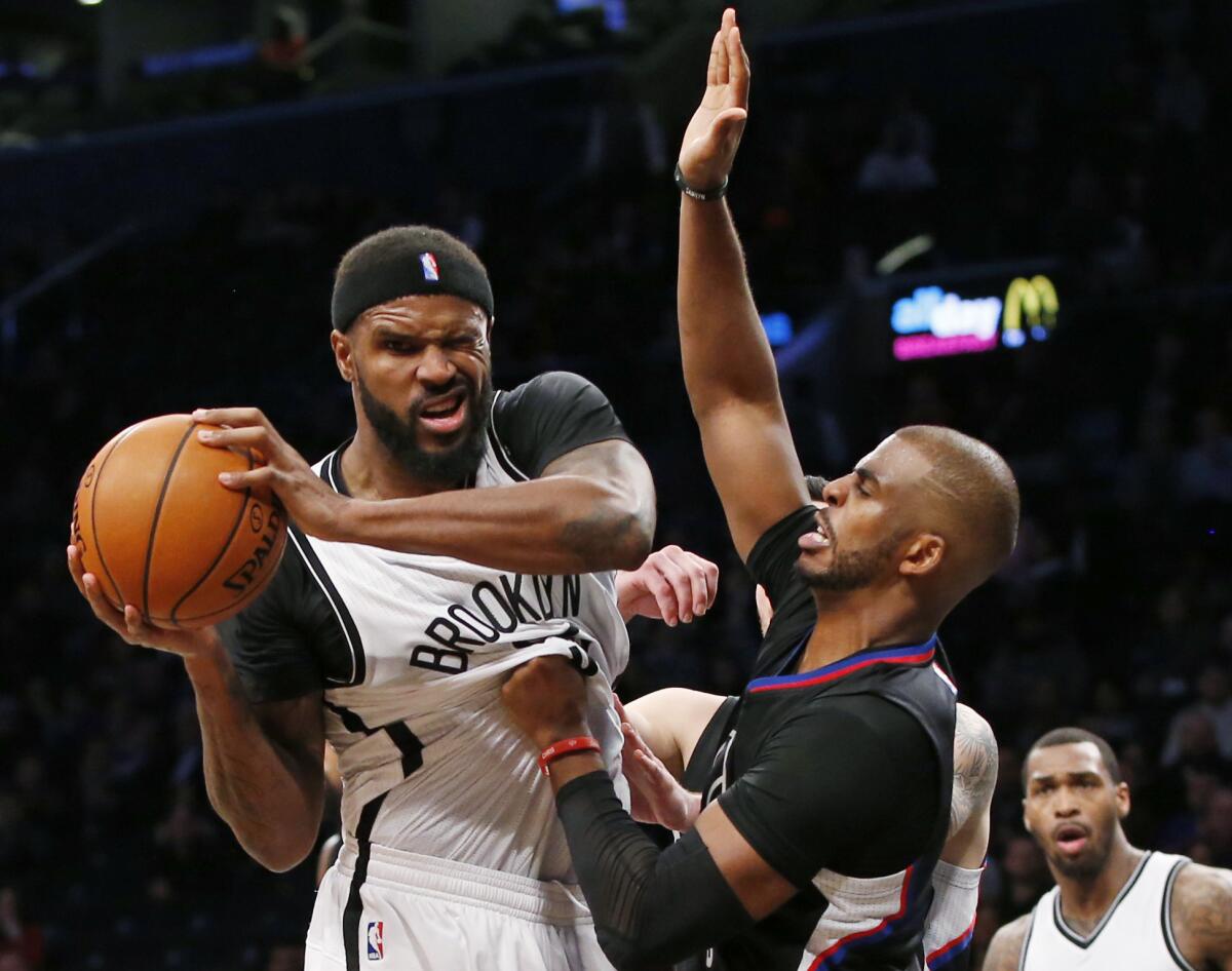 Los Angeles Clippers guard Chris Paul defends Brooklyn Nets guard Isaiah Whitehead, left, who grimaces after being hit in the eye in overtime of an NBA basketball game, Tuesday, Nov. 29, 2016, in New York. The Nets defeated the Clippers 127-122.