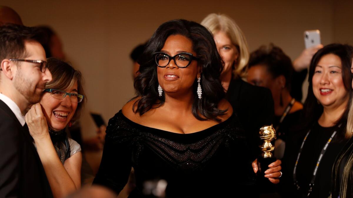 Oprah Winfrey with her Golden Globe Award backstage.