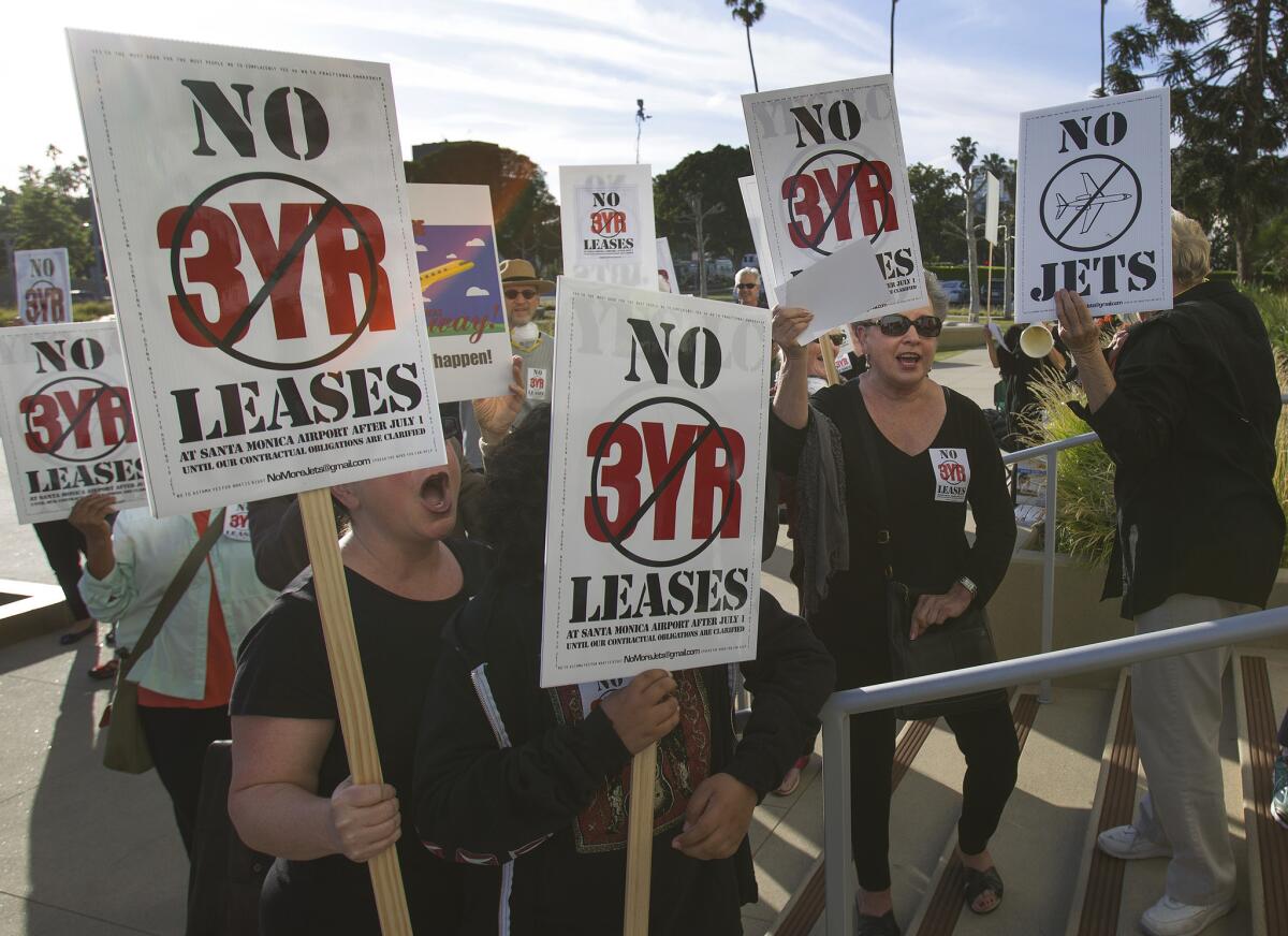 Activists rally outside Santa Monica City Hall last year to protest extending leases for aviation tenants at the city's municipal airport. The City Council has vowed to close the controversial facility in 2018.