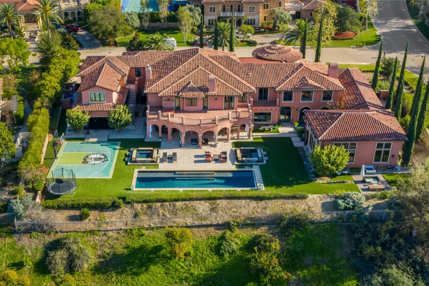 The estate centers on a 12,250-square-foot mansion with six bedrooms, nine bathrooms, a movie theater and bowling alley.