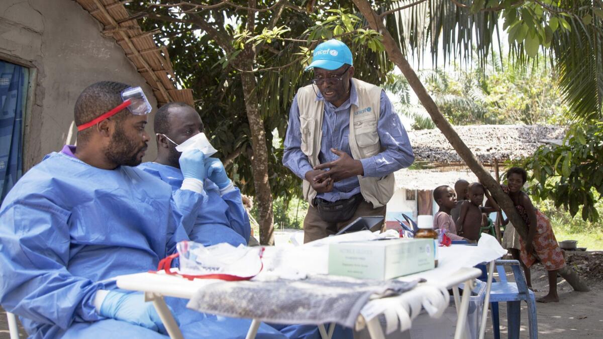UNICEF staffer Jean Claude Nzengu, center, talks with members of an Ebola vaccination team in Mbandaka, Congo, a city of 1.2 million with four confirmed cases.