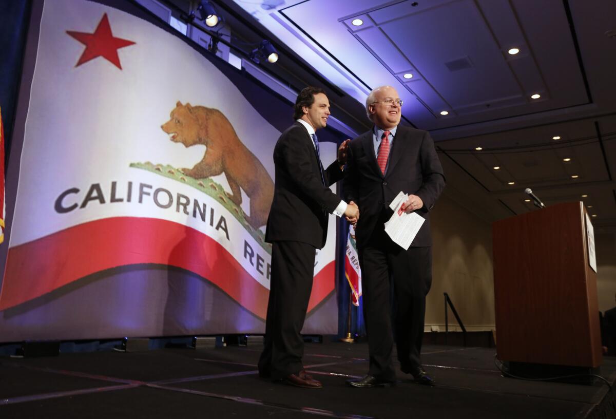 Tom Del Beccaro, then California Republican chairman, shakes hands with GOP strategist Karl Rove, right, at the March 2013 state party convention in Sacramento.