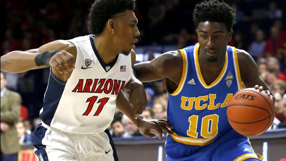 UCLA guard Isaac Hamilton (10) drives against Arizona guard Alonzo Trier during the second half of their game Friday night.
