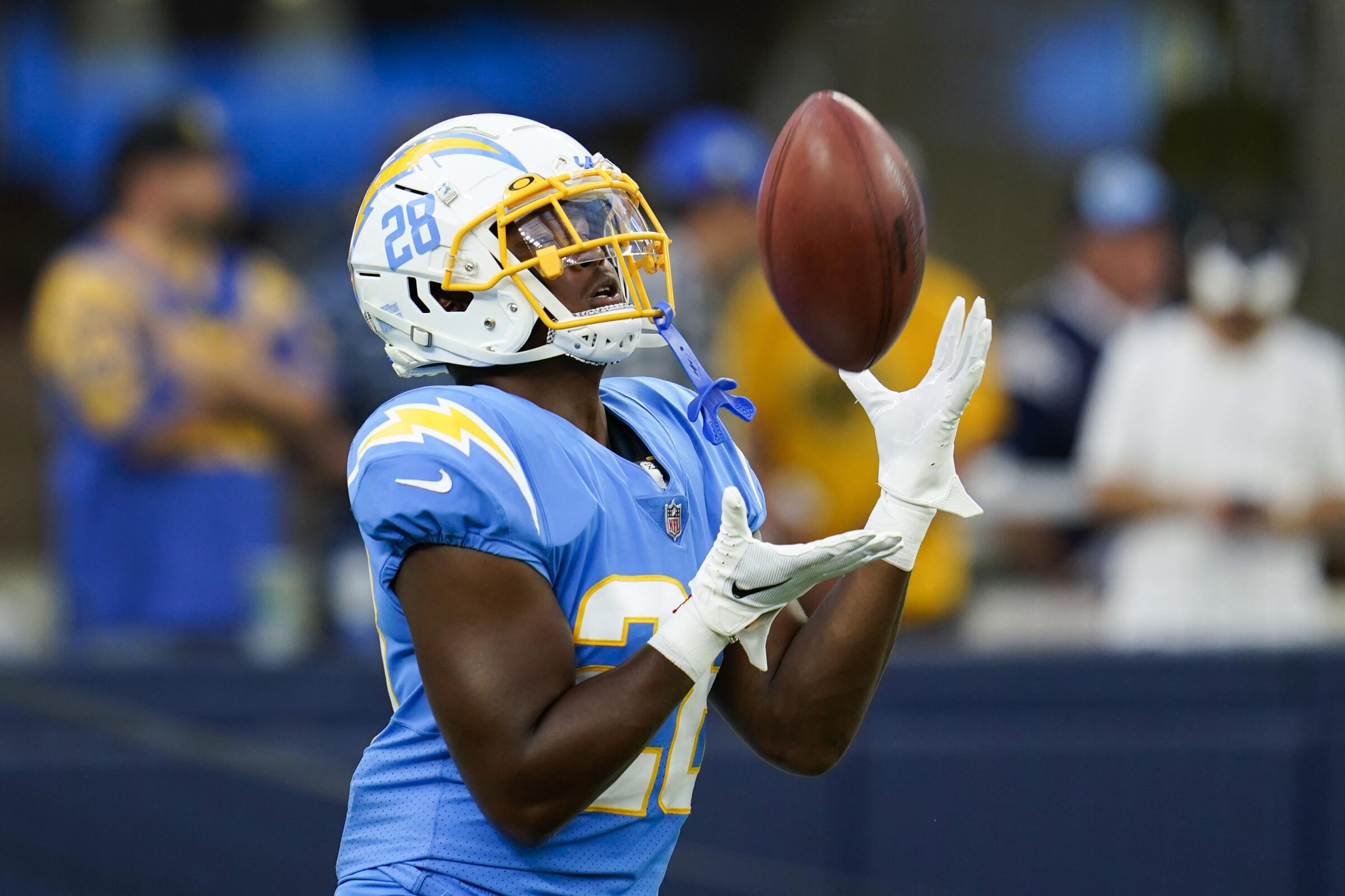 Chargers running back Isaiah Spiller warms up before a preseason game against the Rams.