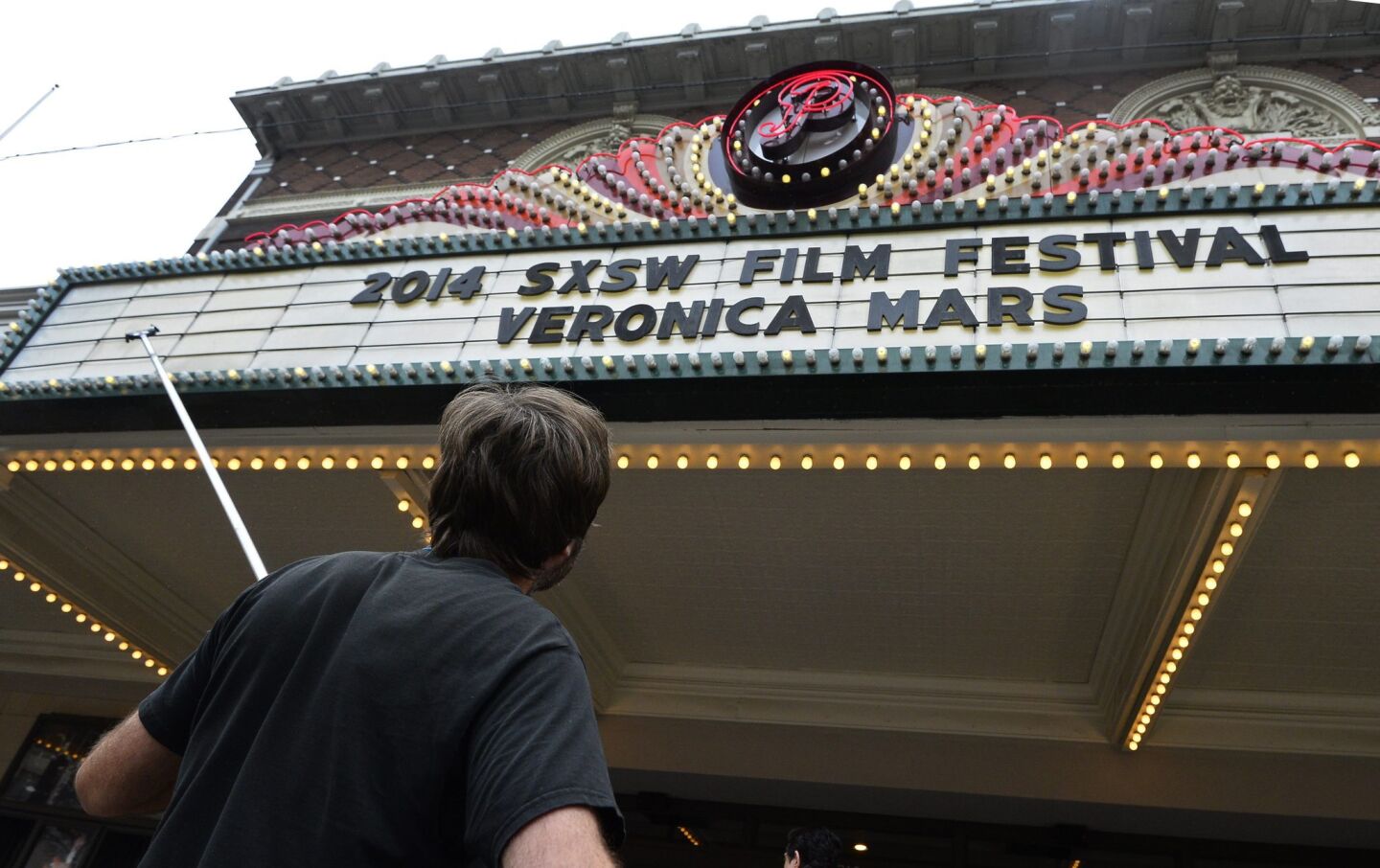 A man changes the movie marquee at one of the theaters showing films on the second day of South by Southwest in Austin, Texas.