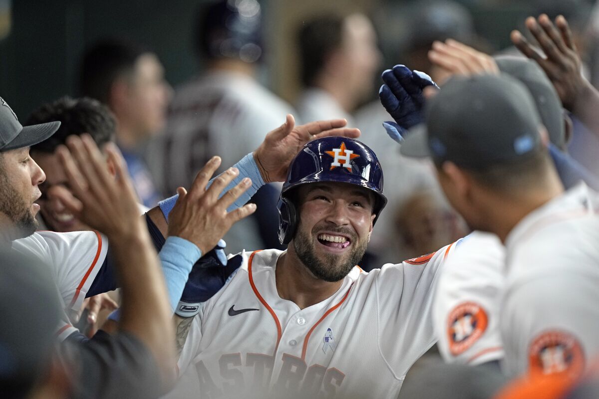 Houston Astros' J.J. Matijevic celebrates with teammates in the dugout after hitting a home run against the Chicago White Sox during the fourth inning of a baseball game Sunday, June 19, 2022, in Houston. Matijevic's home run was his first Major League hit. (AP Photo/David J. Phillip)